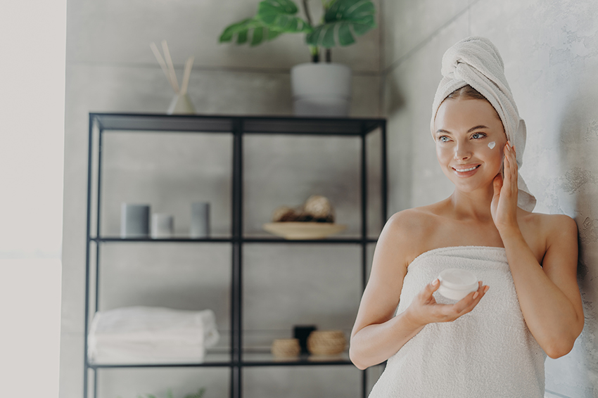 smiling caucasian woman applies beauty cream on ch 2022 08 14 05 15 37 utc